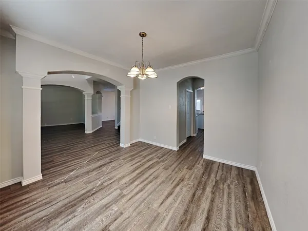 a view of a livingroom with wooden floor and staircase