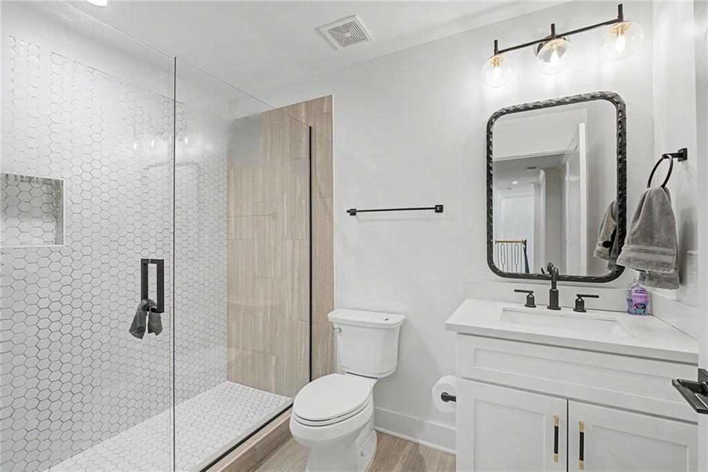 376 Hunnicut Road Southeast Mableton, GA 30126 - Photo 66 of 73 a bathroom with a toilet sink shower and mirror