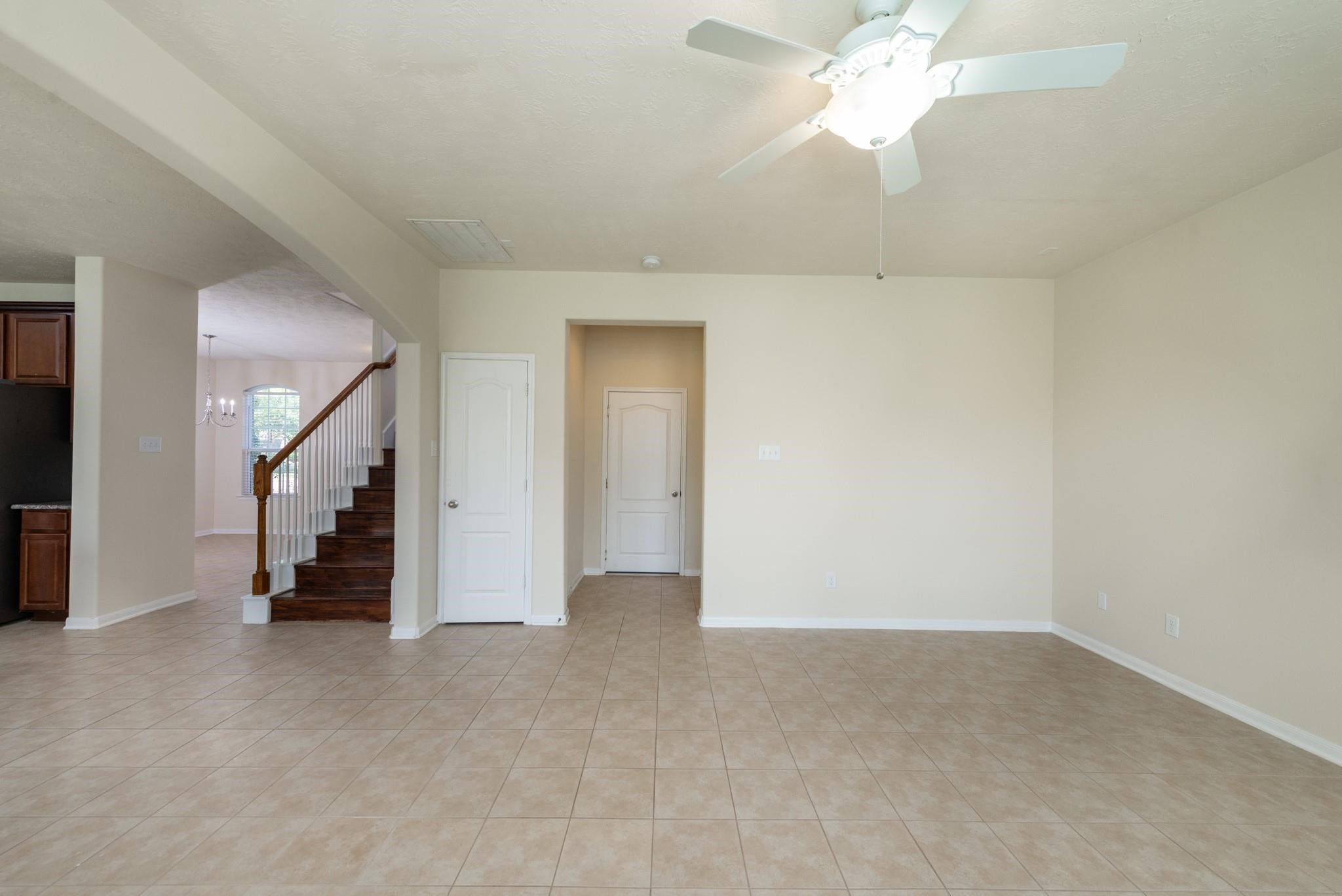 6402 Addlestone Ridge Lane Katy, TX 77494 - Photo 10 of 25 Family room offers plenty of flexibility for furniture placement and entertainment. The open-concept layout flows seamlessly to the kitchen, while the staircase provides convenient access to the upstairs bedrooms and living areas.