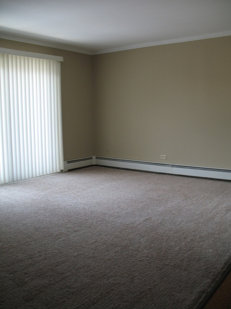 709 65th Street, Unit 5 Westmont, IL 60559 - Photo 4 of 15 a view of an empty room with a window