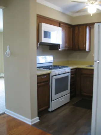 a white refrigerator freezer sitting inside of a kitchen