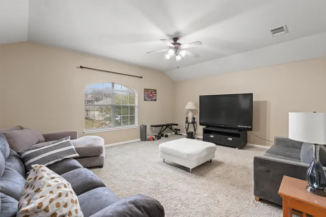 a bedroom with a bed and a lamp on dresser