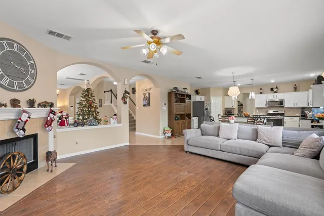 a living room with furniture and a wooden floor