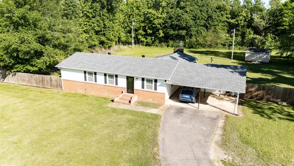 a house with swimming pool in front of it