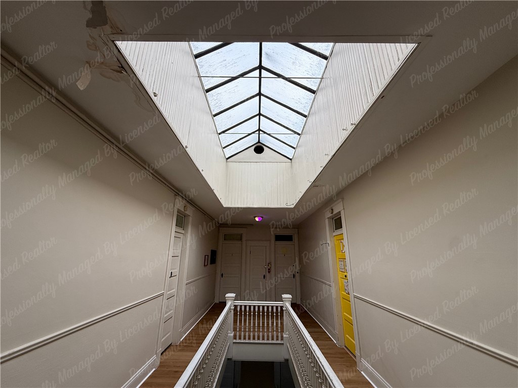 44 West High Street, Unit D Springfield, OH 45502 - Photo 2 of 25 This interior hallway features a distinctive skylight and classic railing details.