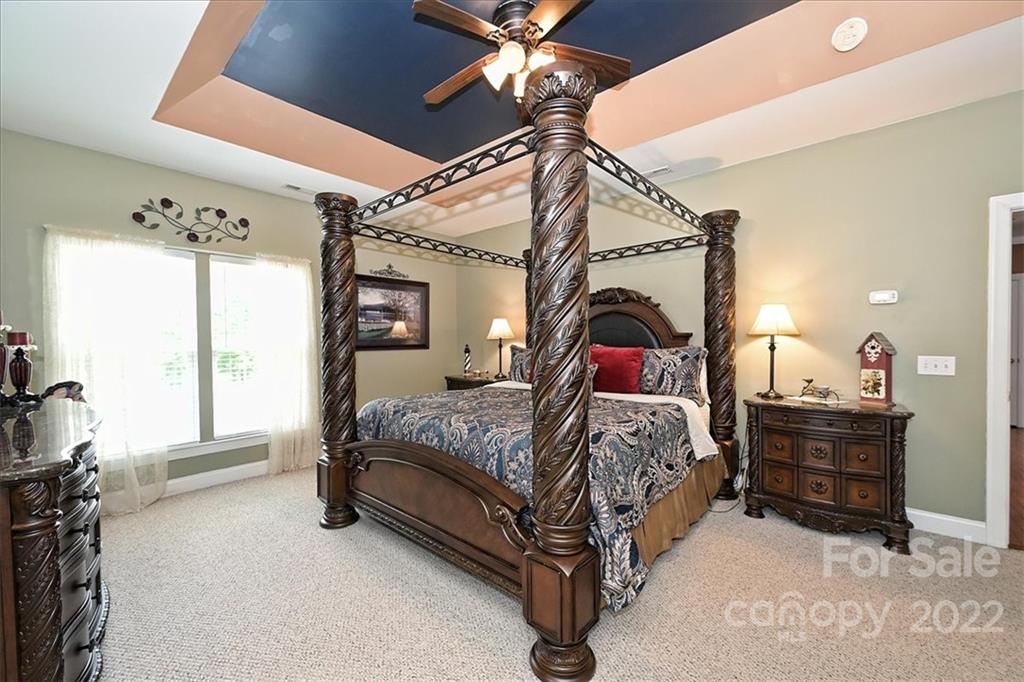728 Beille Lane Fort Mill, SC 29708 - Photo 28 of 48 a bedroom with a bed ceiling fan and a window