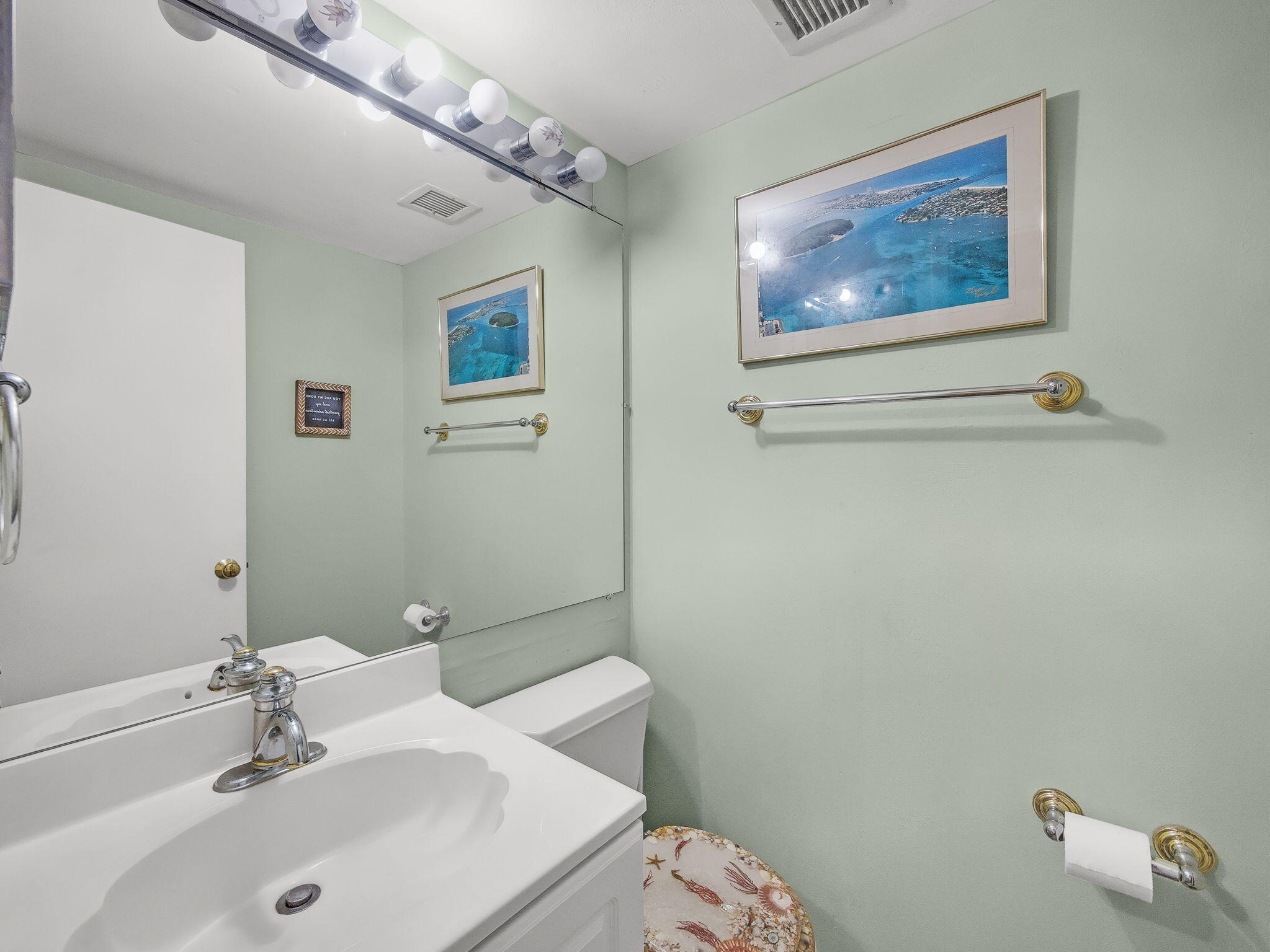 125 South Ocean Avenue, Unit 303 Palm Beach Shores, FL 33404 - Photo 14 of 20 a bathroom with a sink mirror and toilet