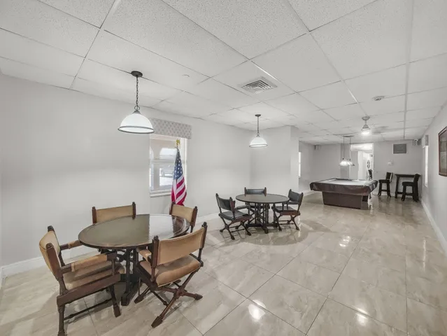 a living room with lots of furniture a rug and a chandelier