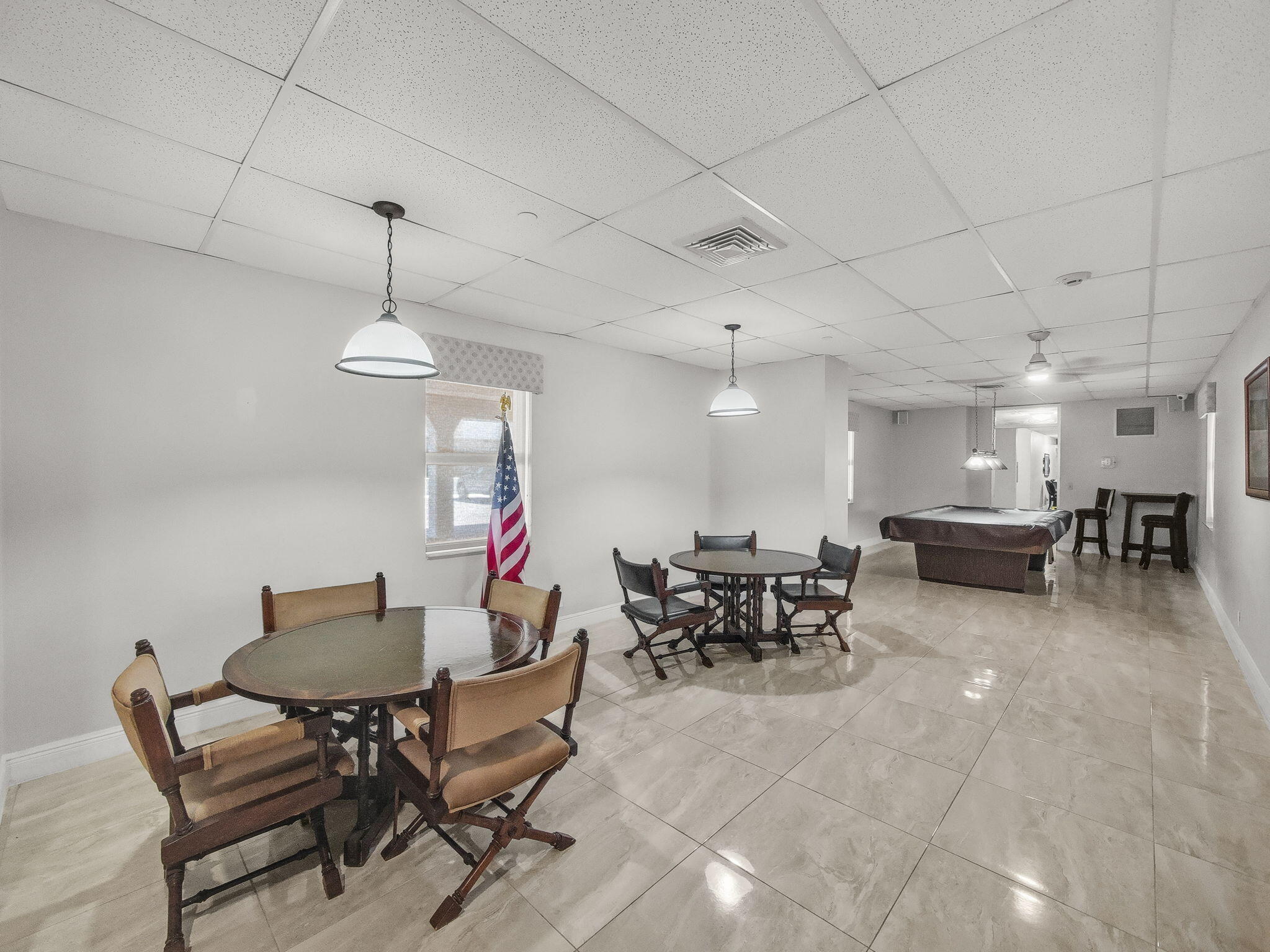 125 South Ocean Avenue, Unit 303 Palm Beach Shores, FL 33404 - Photo 17 of 20 a living room with lots of furniture a rug and a chandelier