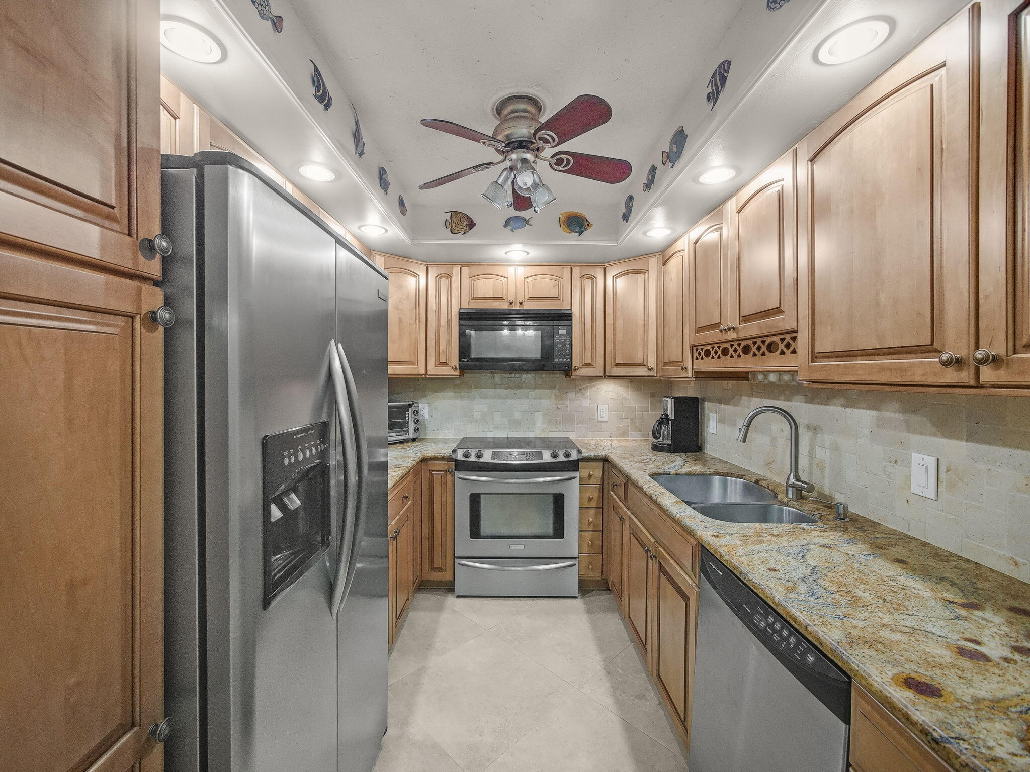 125 South Ocean Avenue, Unit 303 Palm Beach Shores, FL 33404 - Photo 10 of 20 a kitchen with stainless steel appliances granite countertop a sink a stove and a refrigerator