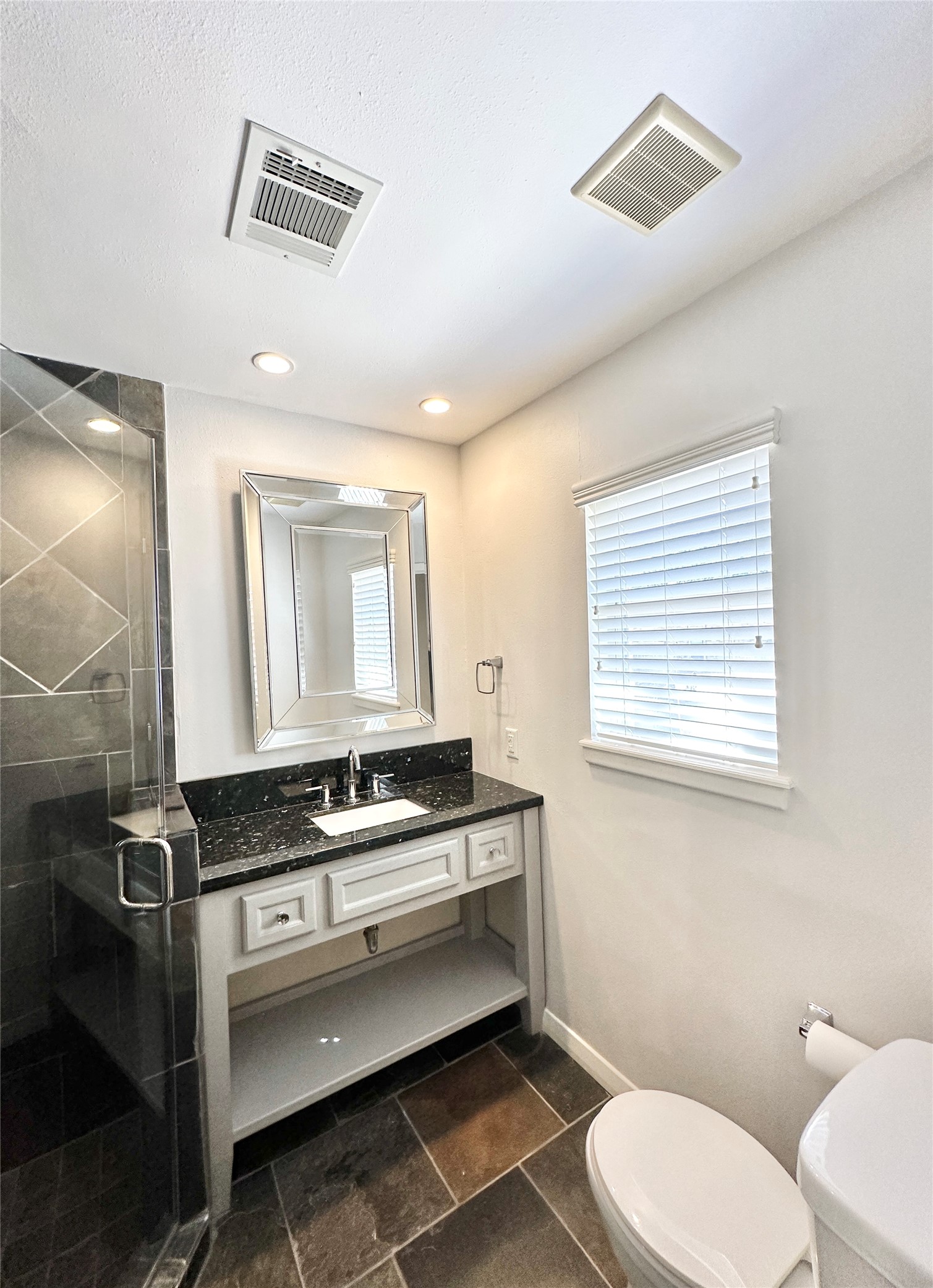 22 Champions Colony West Houston, TX 77069 - Photo 12 of 14 a bathroom with a granite countertop toilet sink and mirror