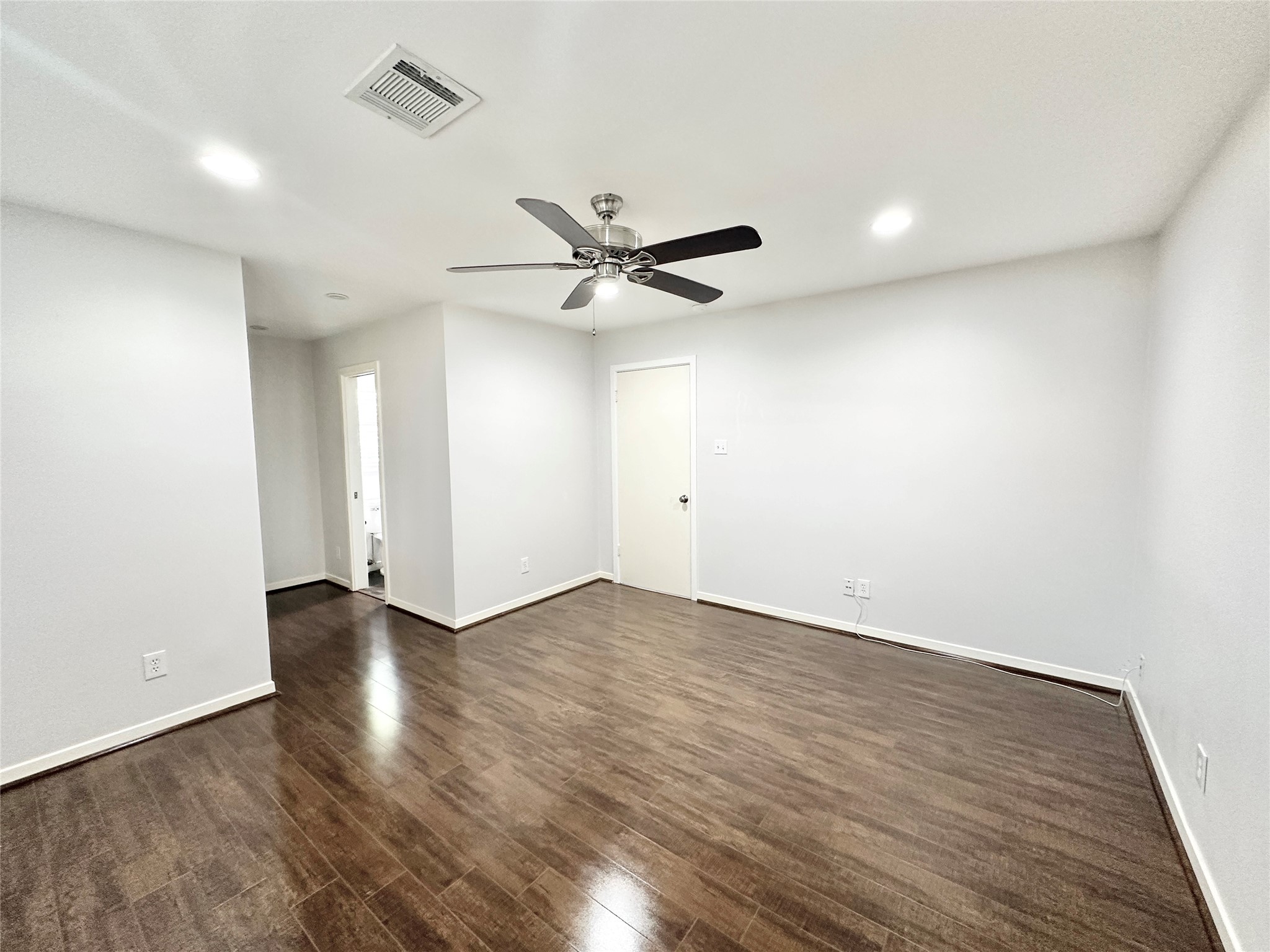 22 Champions Colony West Houston, TX 77069 - Photo 9 of 14 an empty room with wooden floor and ceiling fan