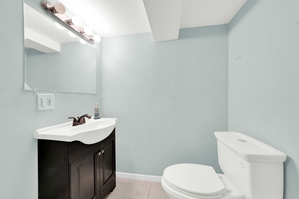 7234 South Ridgeway Avenue Chicago, IL 60629 - Photo 20 of 27 a bathroom with a sink a toilet and a mirror