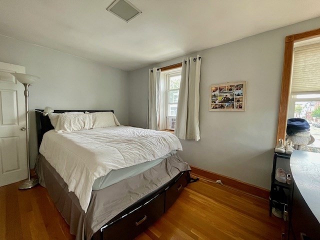 125 Farragut Road, Unit 46 Boston, MA 02127 - Photo 11 of 15 a bedroom with a bed and wooden floor