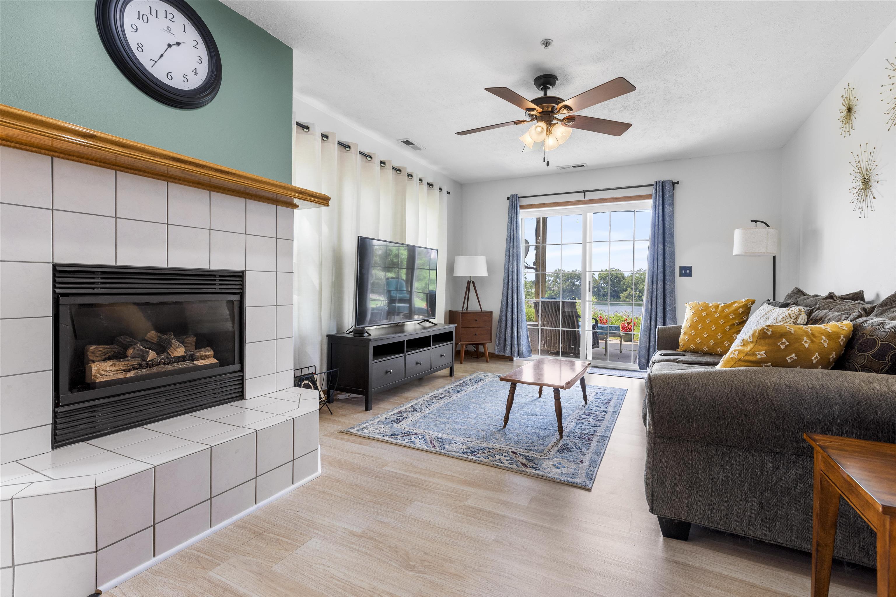 7280 North Alpine Road, Unit 1 Loves Park, IL 61111 - Photo 1 of 14 a living room with furniture a fireplace and a large window