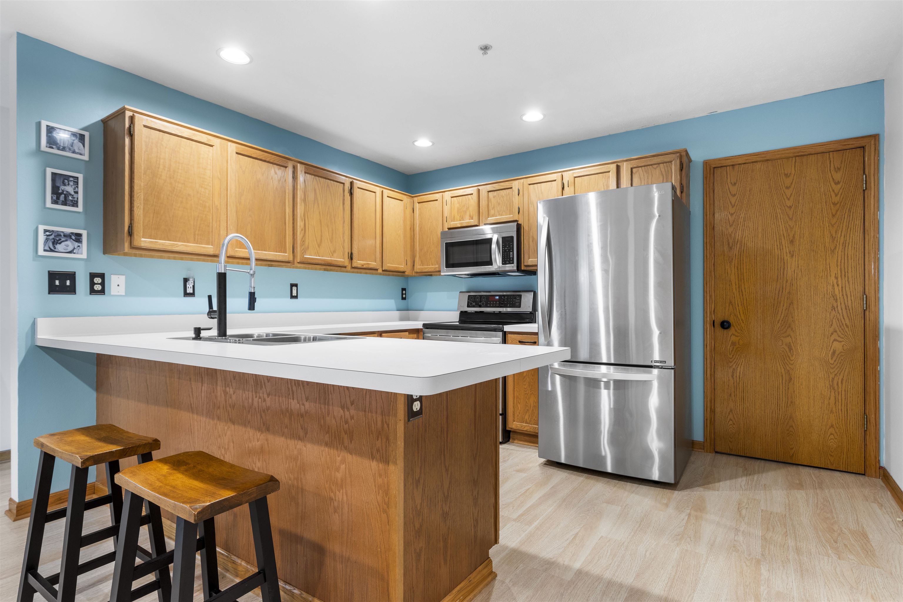 7280 North Alpine Road, Unit 1 Loves Park, IL 61111 - Photo 4 of 14 a kitchen with stainless steel appliances a sink a stove a refrigerator and cabinets