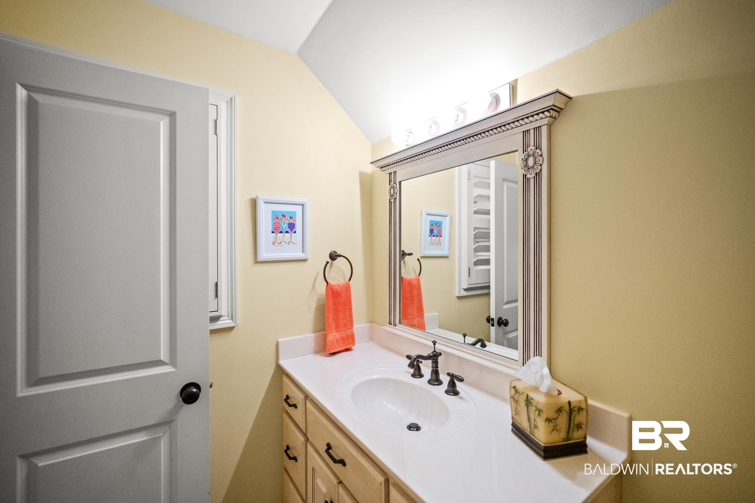 404 Peninsula Boulevard Gulf Shores, AL 36542 - Photo 26 of 51 Bathroom with vanity and vaulted ceiling
