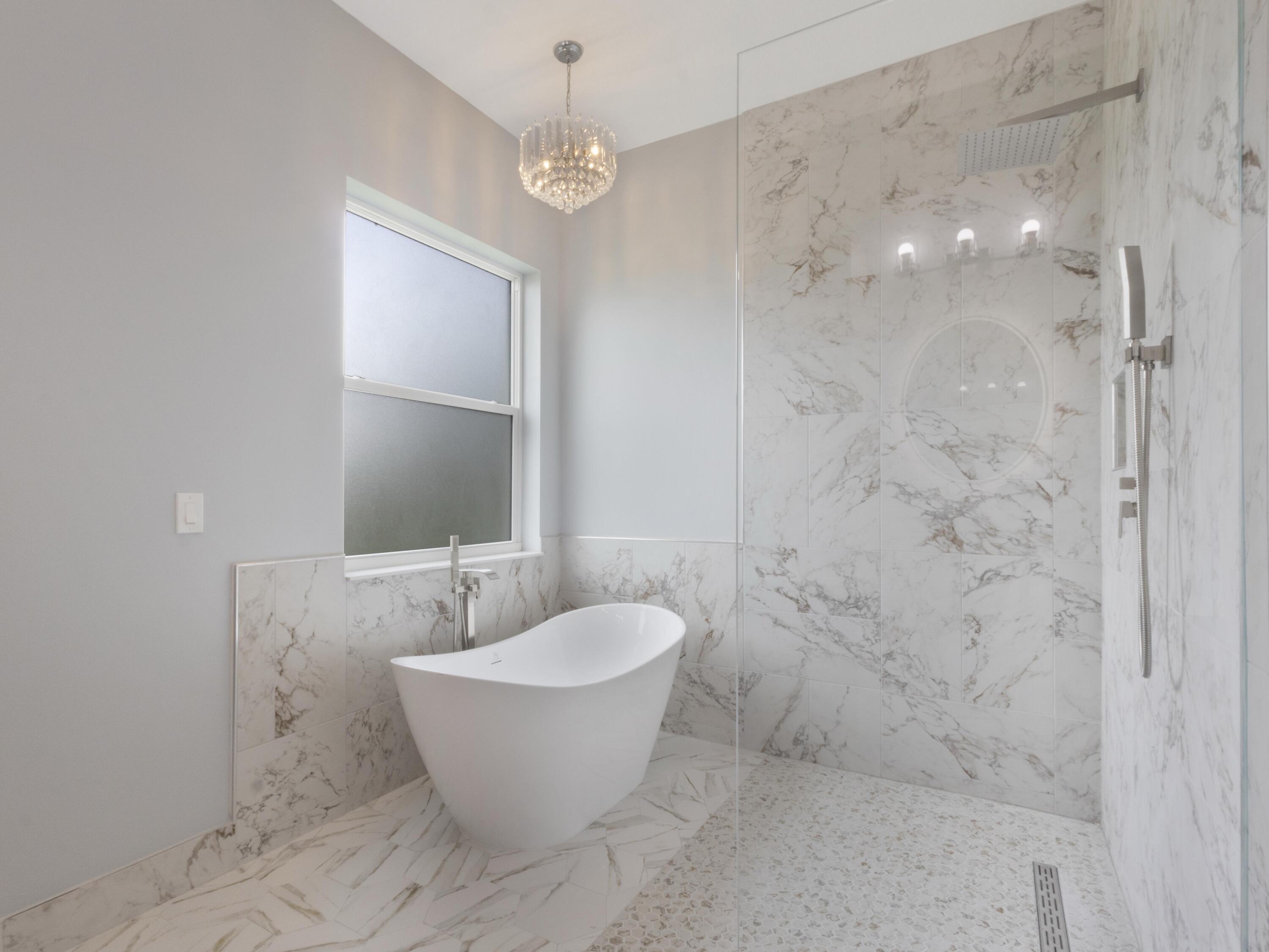 17436 71st Lane North Loxahatchee, FL 33470 - Photo 32 of 50 a bathroom with a bathtub and shower
