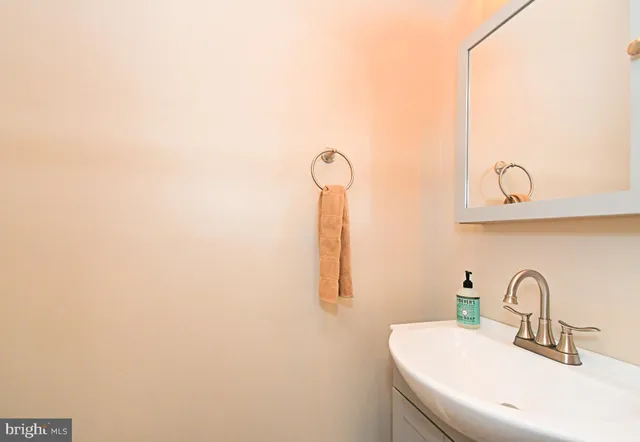 a bathroom with a sink and mirror