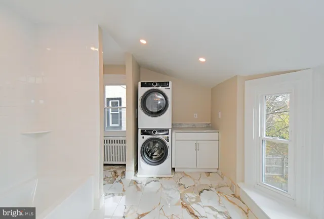 a utility room with sink dryer and washer