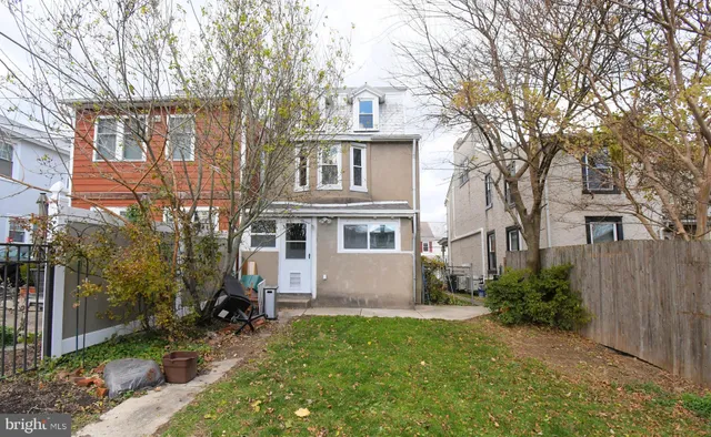 a front view of house with yard and trees around