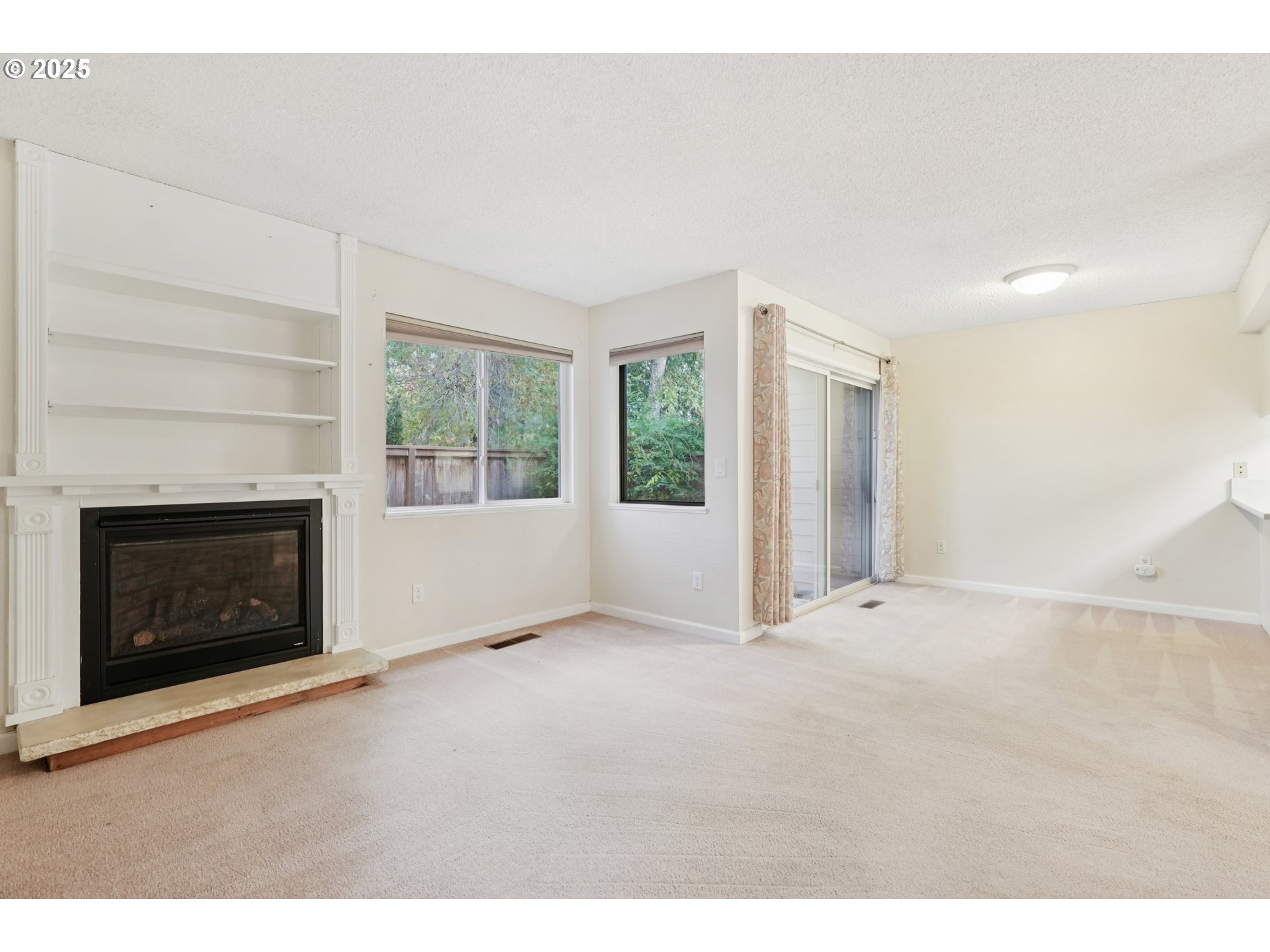 14678 Southwest 106th Avenue Tigard, OR 97224 - Photo 11 of 41 a view of an empty room with window and fire place