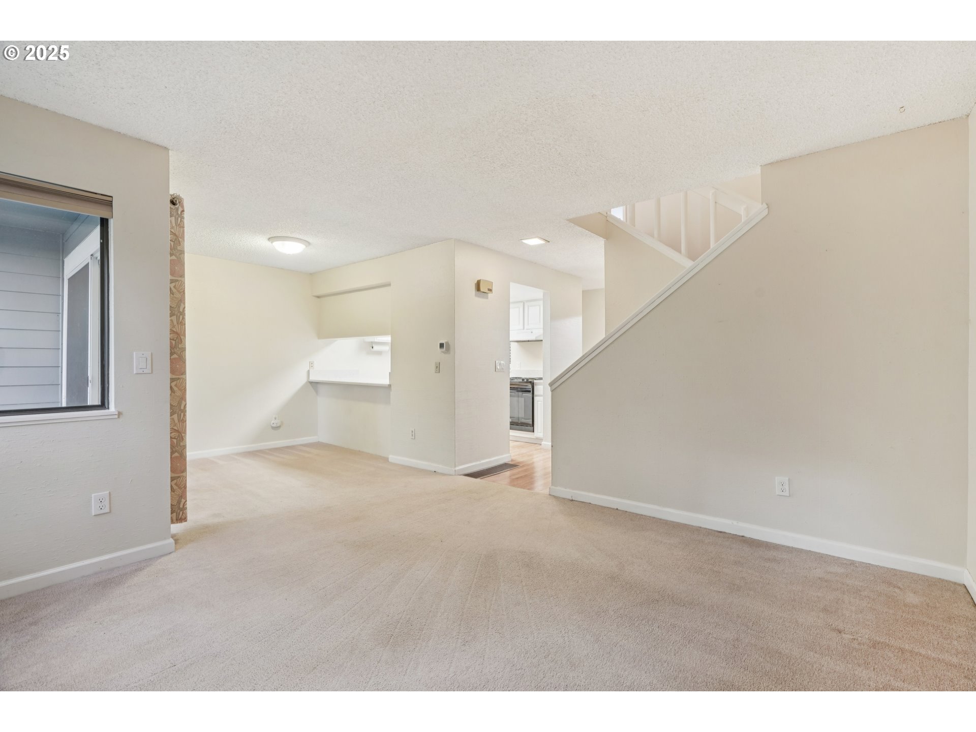 14678 Southwest 106th Avenue Tigard, OR 97224 - Photo 12 of 41 a view of an empty room with a kitchen
