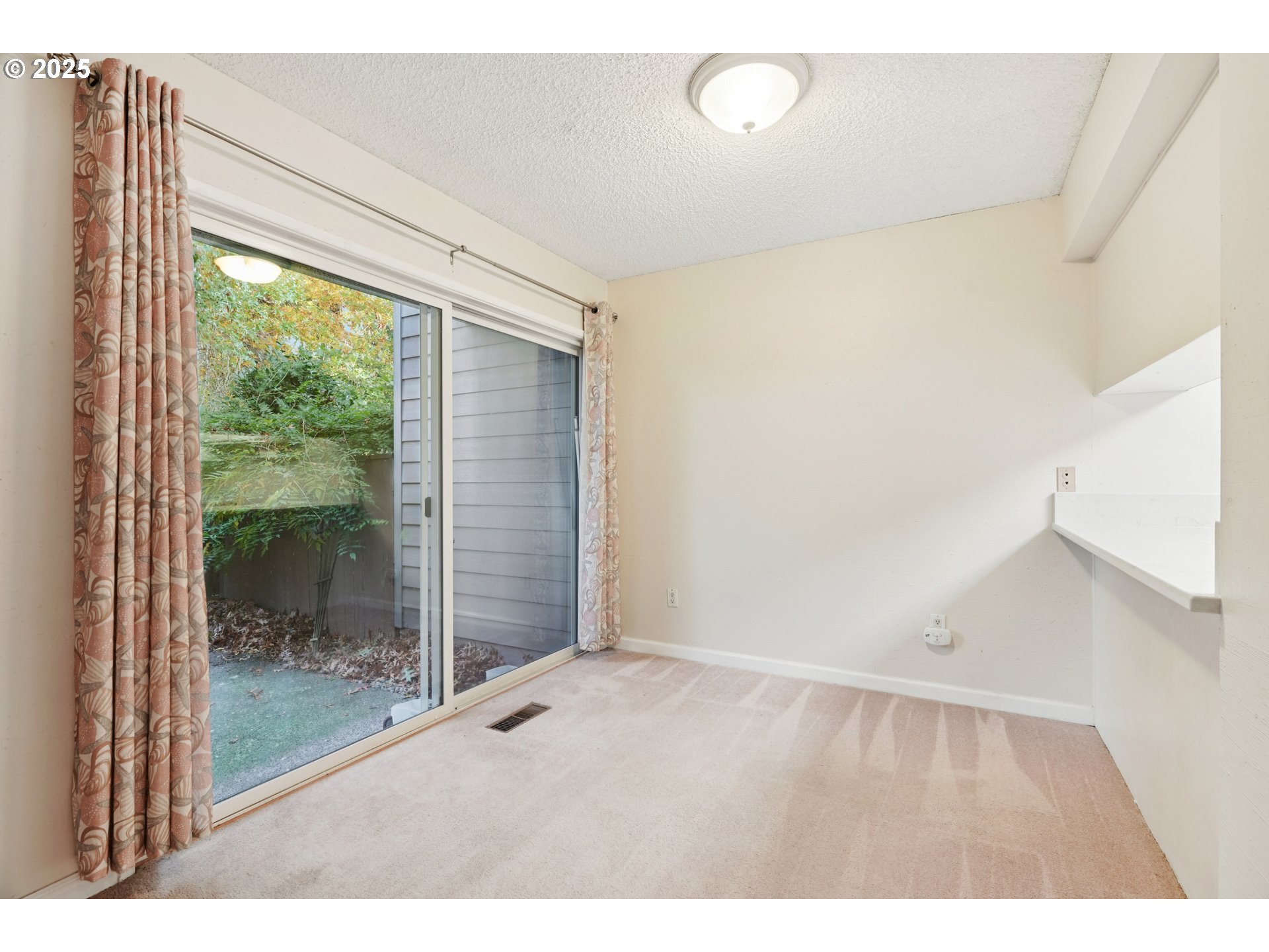 14678 Southwest 106th Avenue Tigard, OR 97224 - Photo 13 of 41 a view of an empty room with wooden floor and a window