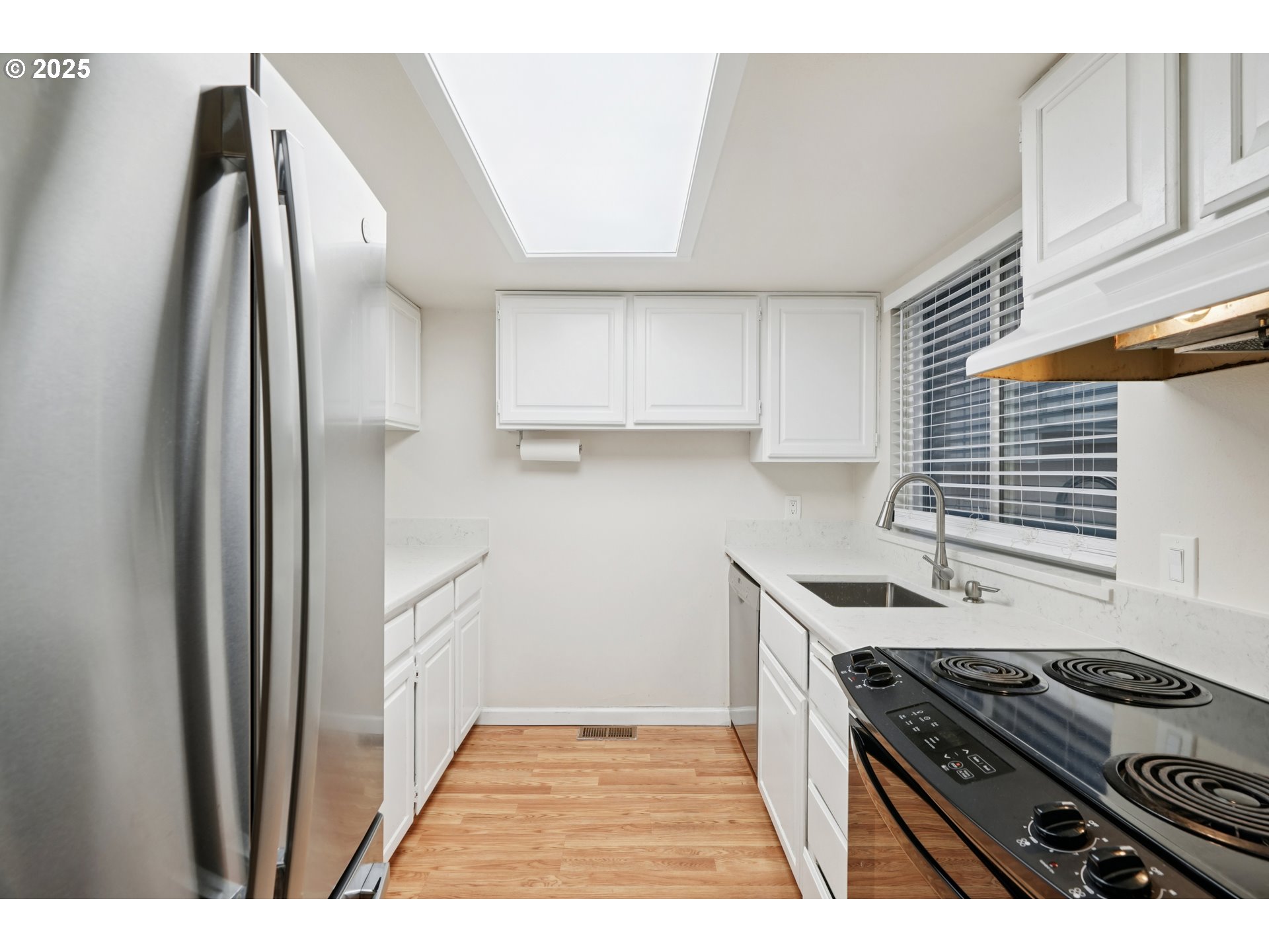14678 Southwest 106th Avenue Tigard, OR 97224 - Photo 16 of 41 a kitchen with stainless steel appliances granite countertop a stove and a refrigerator