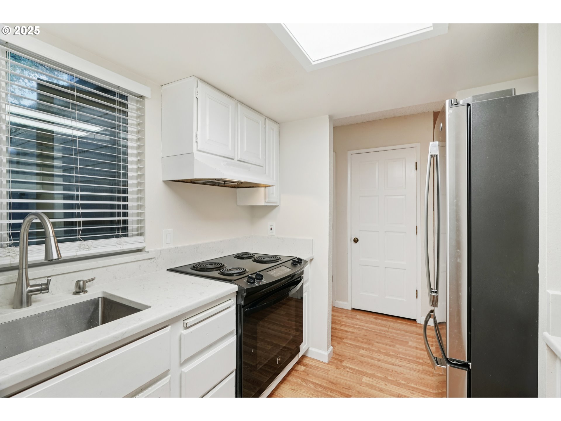 14678 Southwest 106th Avenue Tigard, OR 97224 - Photo 19 of 41 a kitchen with stainless steel appliances granite countertop a sink stove and a refrigerator