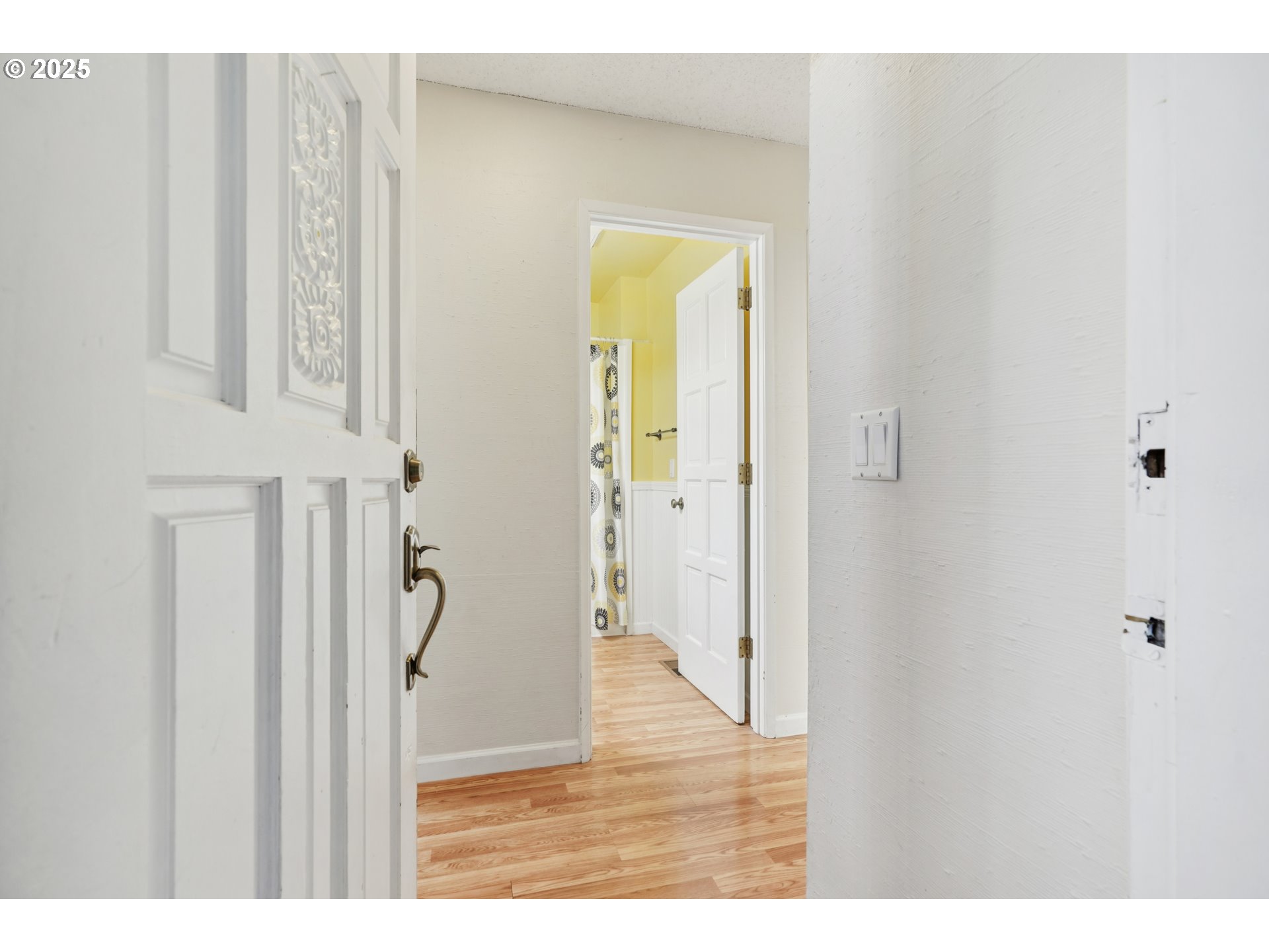 14678 Southwest 106th Avenue Tigard, OR 97224 - Photo 8 of 41 a view of a hallway with wooden floor and staircase
