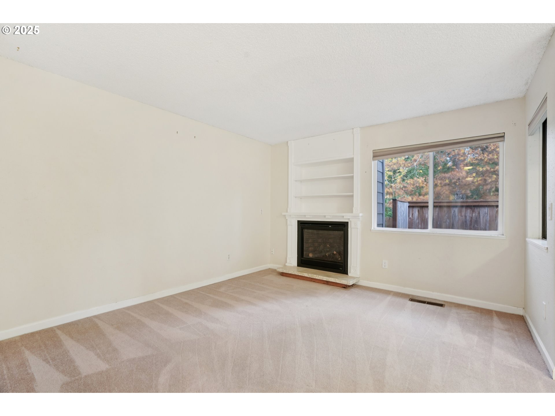 14678 Southwest 106th Avenue Tigard, OR 97224 - Photo 9 of 41 a view of empty room with a fireplace