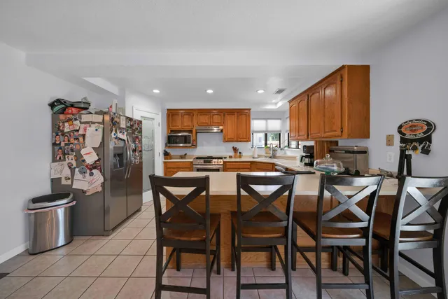 a view of a dining room with furniture and chandelier