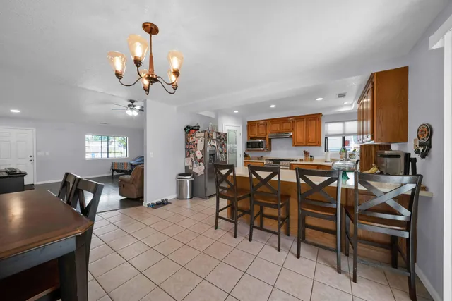 a kitchen with a sink a counter top space stainless steel appliances cabinets and a counter top space