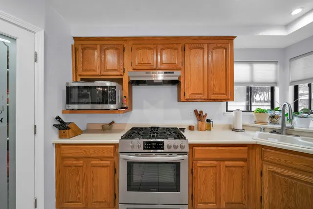 a spacious bedroom with a bed and a ceiling fan