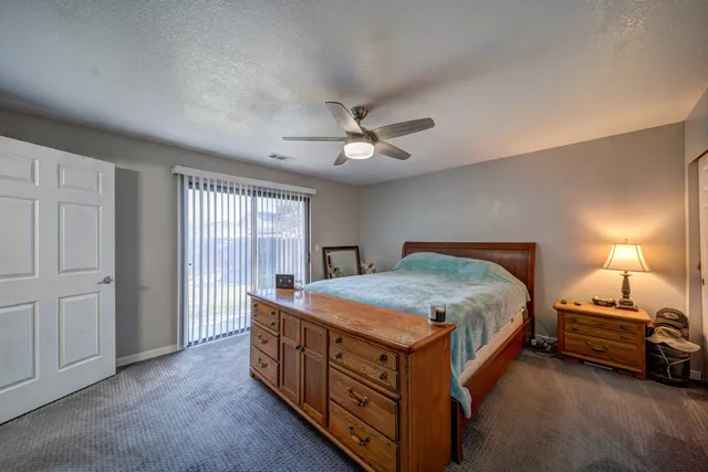 a room with kitchen island a sink and wooden floor