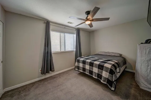 a bedroom with a bed and a tv