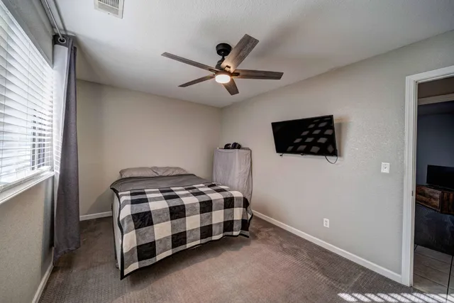 a bedroom with a bed and a flat screen tv