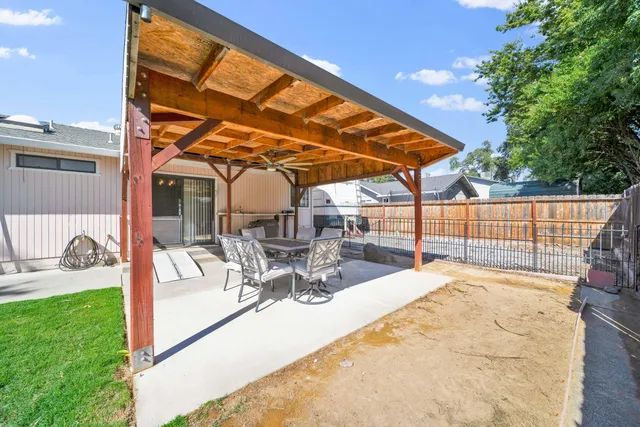 a view of a house with backyard porch and sitting area