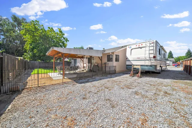 a view of a backyard with a patio and a garden