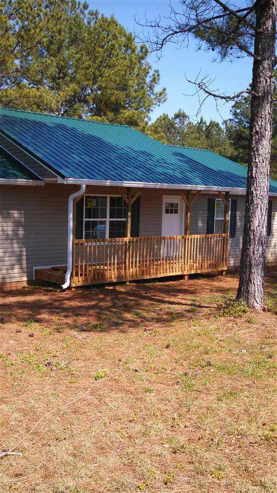 205 Rivers Edge Lane Benton, TN 37307 - Photo 4 of 19 a front view of a house with a garden