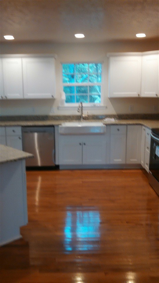 205 Rivers Edge Lane Benton, TN 37307 - Photo 9 of 19 a view of a kitchen with kitchen island a sink wooden floor and a large window