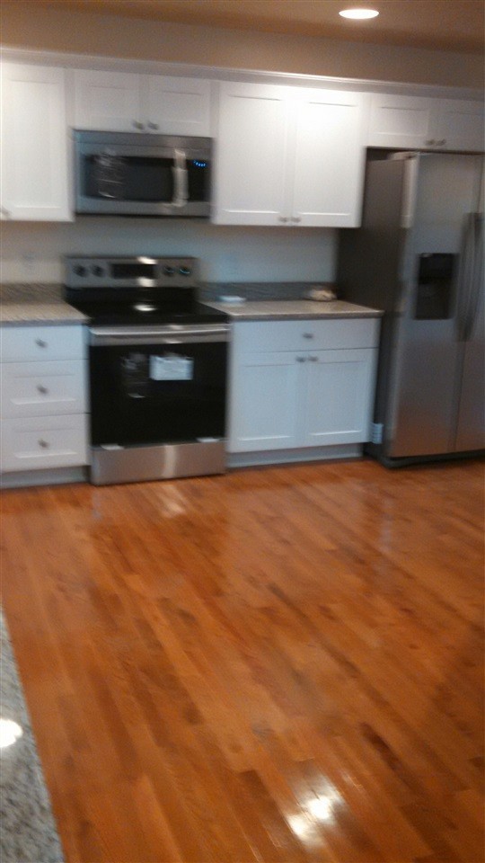 205 Rivers Edge Lane Benton, TN 37307 - Photo 10 of 19 a kitchen with stainless steel appliances wooden cabinets and a granite counter tops