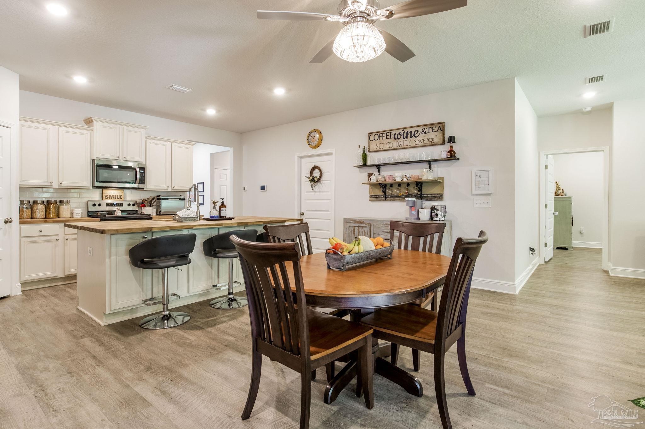 7990 Burnside Loop Pensacola, FL 32526 - Photo 11 of 61 a view of a dining room with furniture and a chandelier