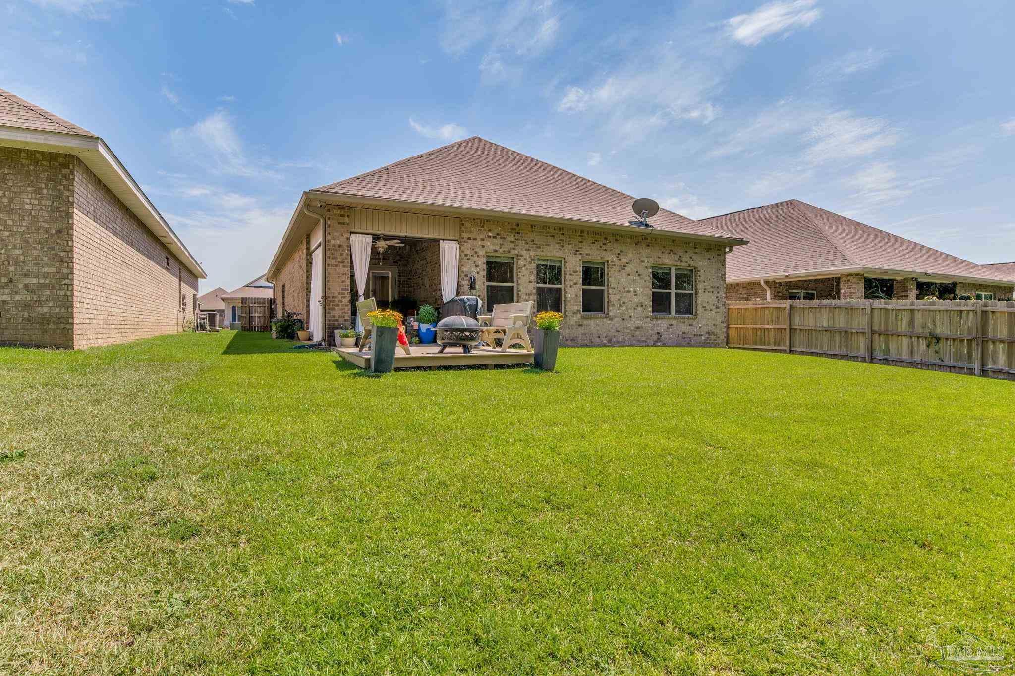 7990 Burnside Loop Pensacola, FL 32526 - Photo 47 of 61 a view of a house with a yard and sitting area