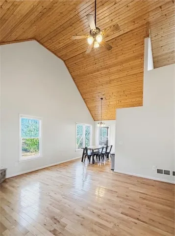 a living room with furniture a rug a fireplace and a large window