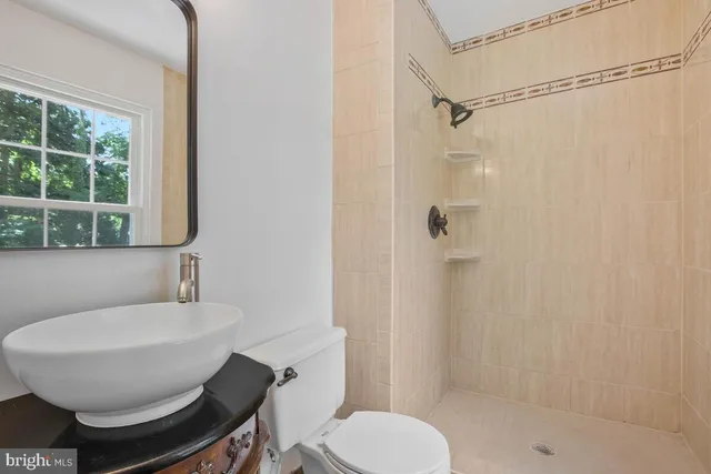 a bathroom with a toilet a sink and shower