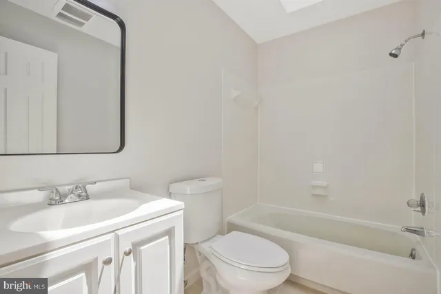 a bathroom with a sink toilet vanity and shower