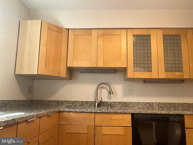 a kitchen with granite countertop a sink and a window