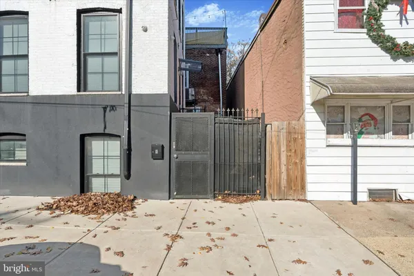 a view of a house with a wooden fence